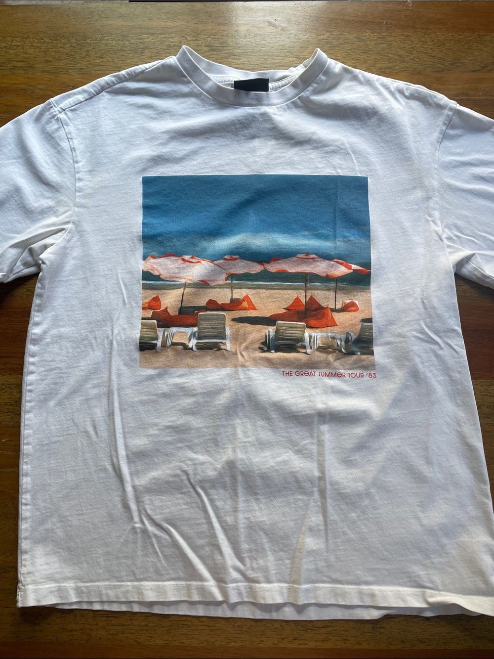 H&M White Tee with Blue Sky and Orange Beach Umbrella Graphic
